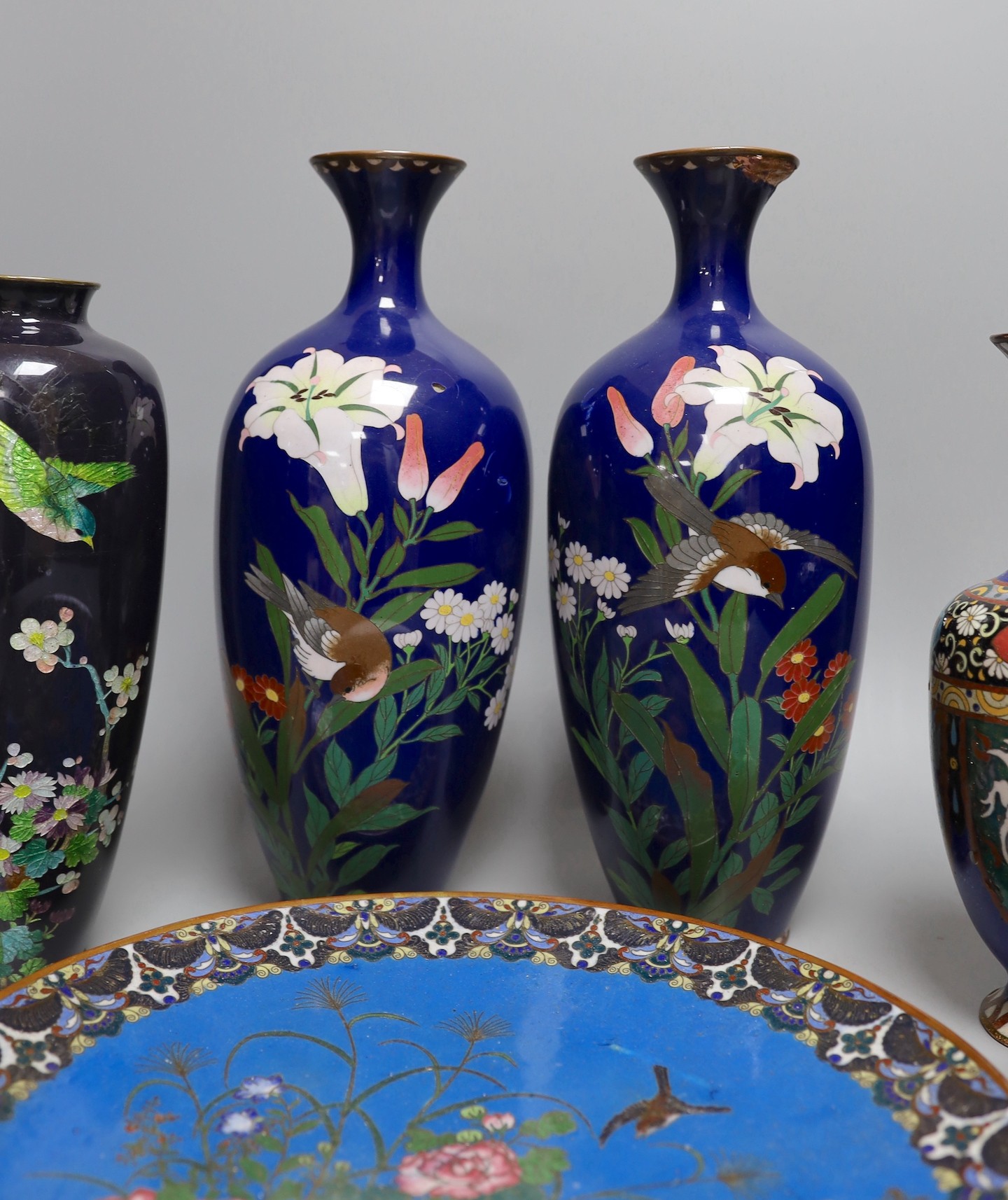 A group of Japanese cloisonné enamel wares to include a pair of vases, two other vases and a dish, Meiji period